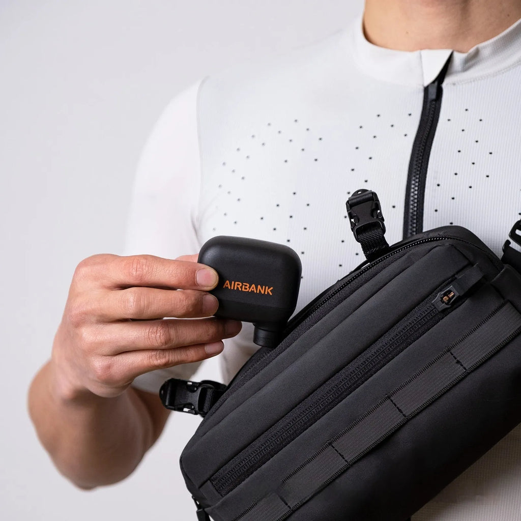 Black mini electric bike pump with USB charging cable and waterproof storage bag for portable bicycle tyre inflation