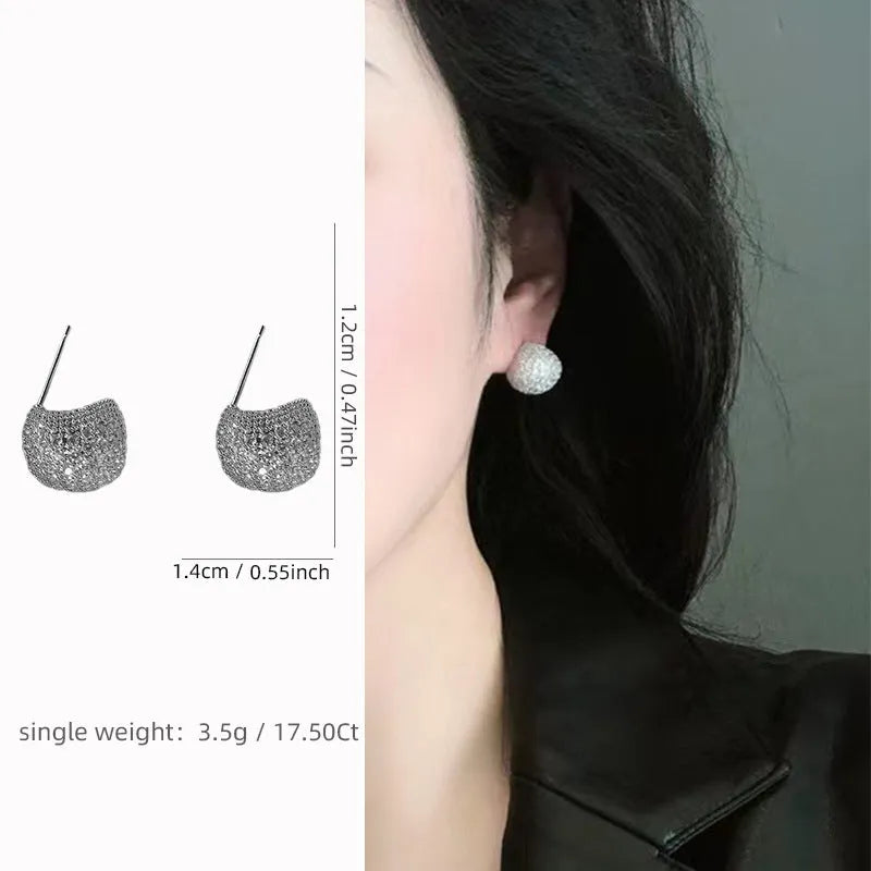 Gold geometric drop earrings with diamond patterning and sphere elements