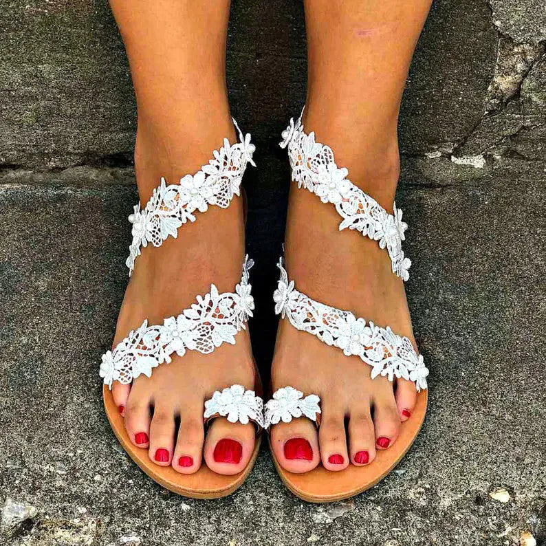 White women's flat shoes with rhinestone and floral pattern on patent PU upper, round toe, low back.