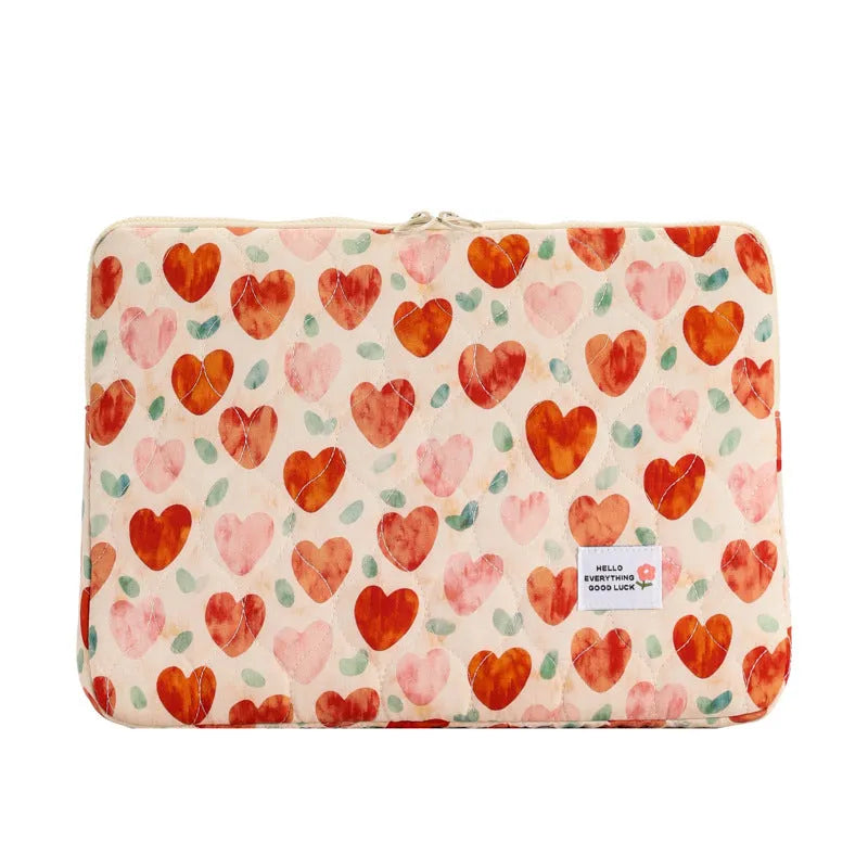 Green floral print cloth laptop bag shown next to red heart and pink floral design options.