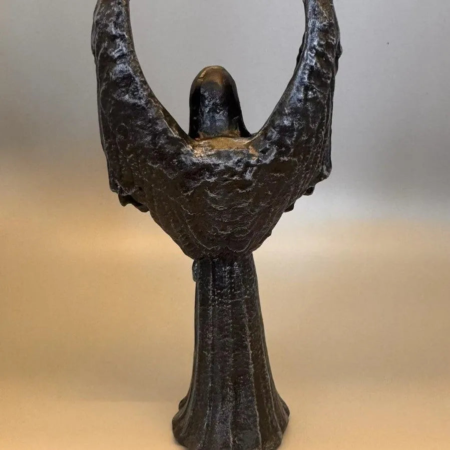 Dark coloured resin angel statue ornament with dimensions 6.5 cm by 5 cm by 17 cm.