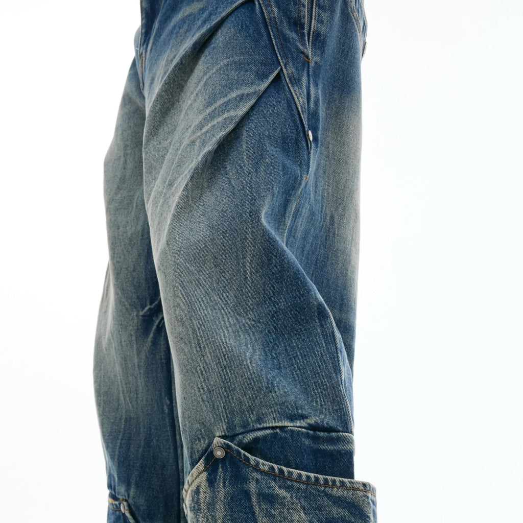Man wearing verdant blue retro washed burst pattern jeans with a curved knife cut and loose fit.