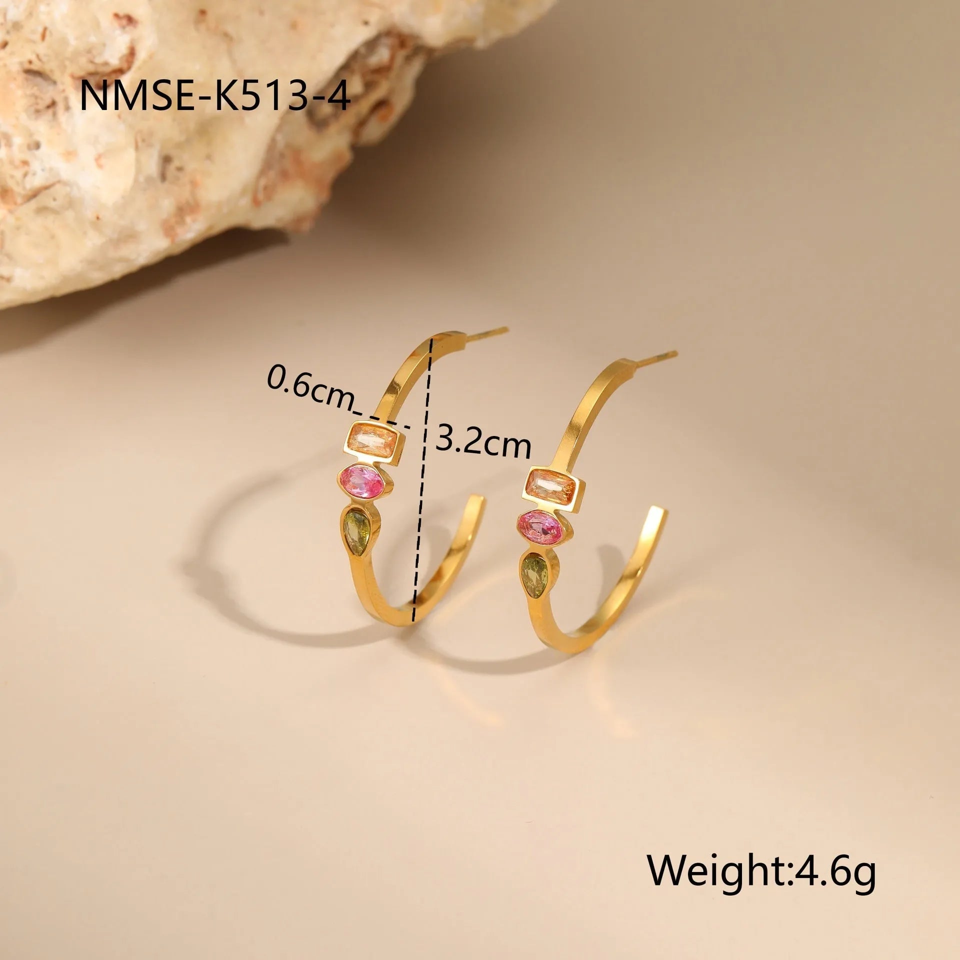 Geometric gold plated jewellery set on display showing drop necklace, U shape necklace, ring, and earrings with zircon accents.