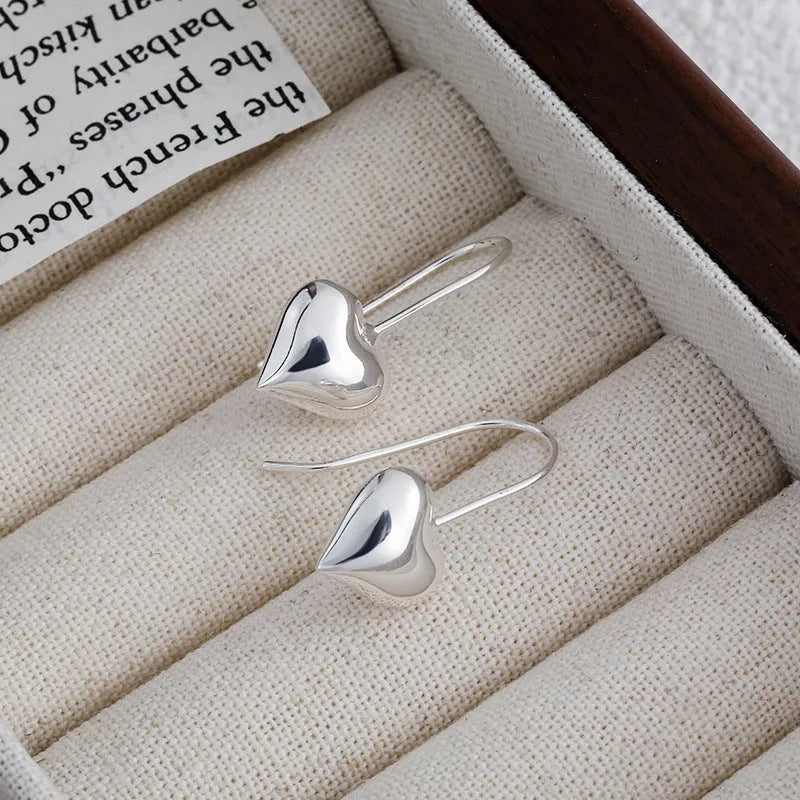 Three-dimensional copper heart earrings with glossy finish and Korean-style design