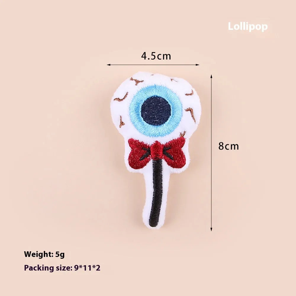 Small colourful plush cat teaser toy with candy, eyes and skull attachments