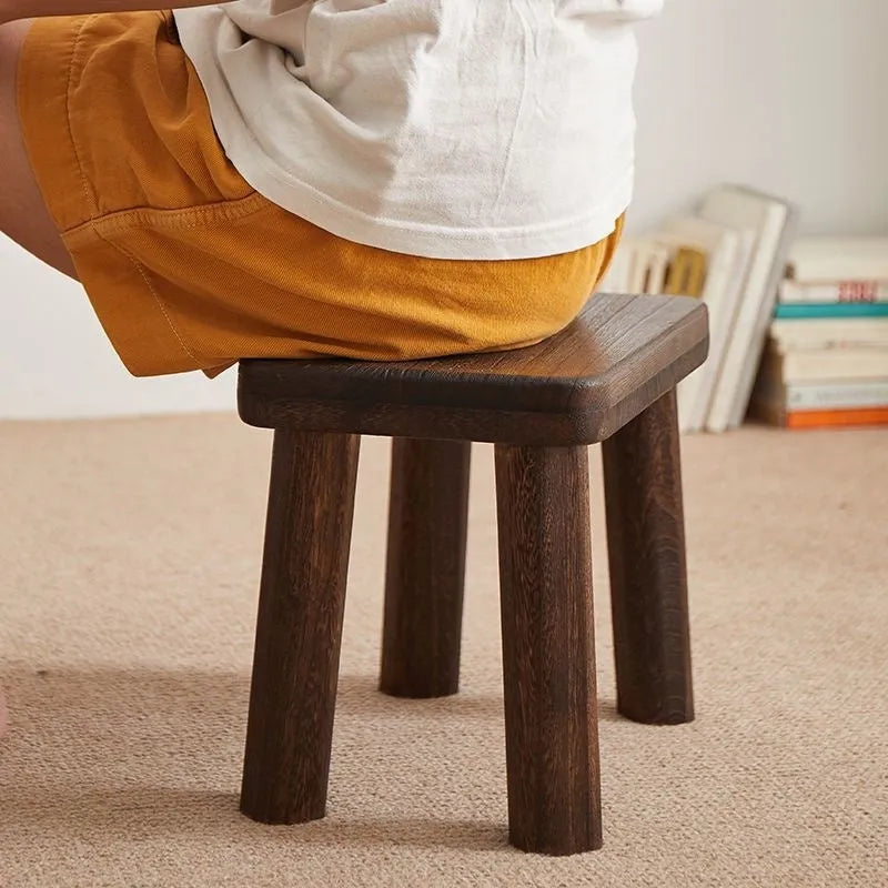 Solid wood household changing stool with a distressed wooden finish.