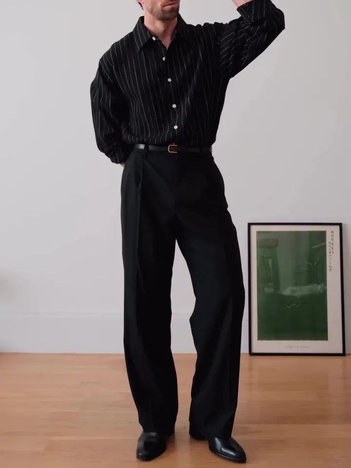 Black pinstriped polyester button-down shirt on a hanger showing regular fit
