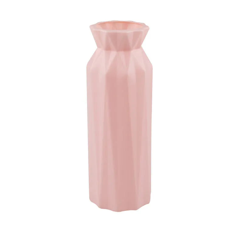 Simple green melamine plastic vase with a wide 7.2 cm base on a wooden table.