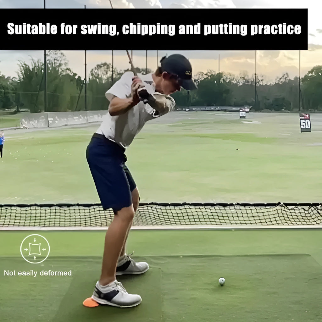 Orange golf training mat with rubber centre disc on practice surface