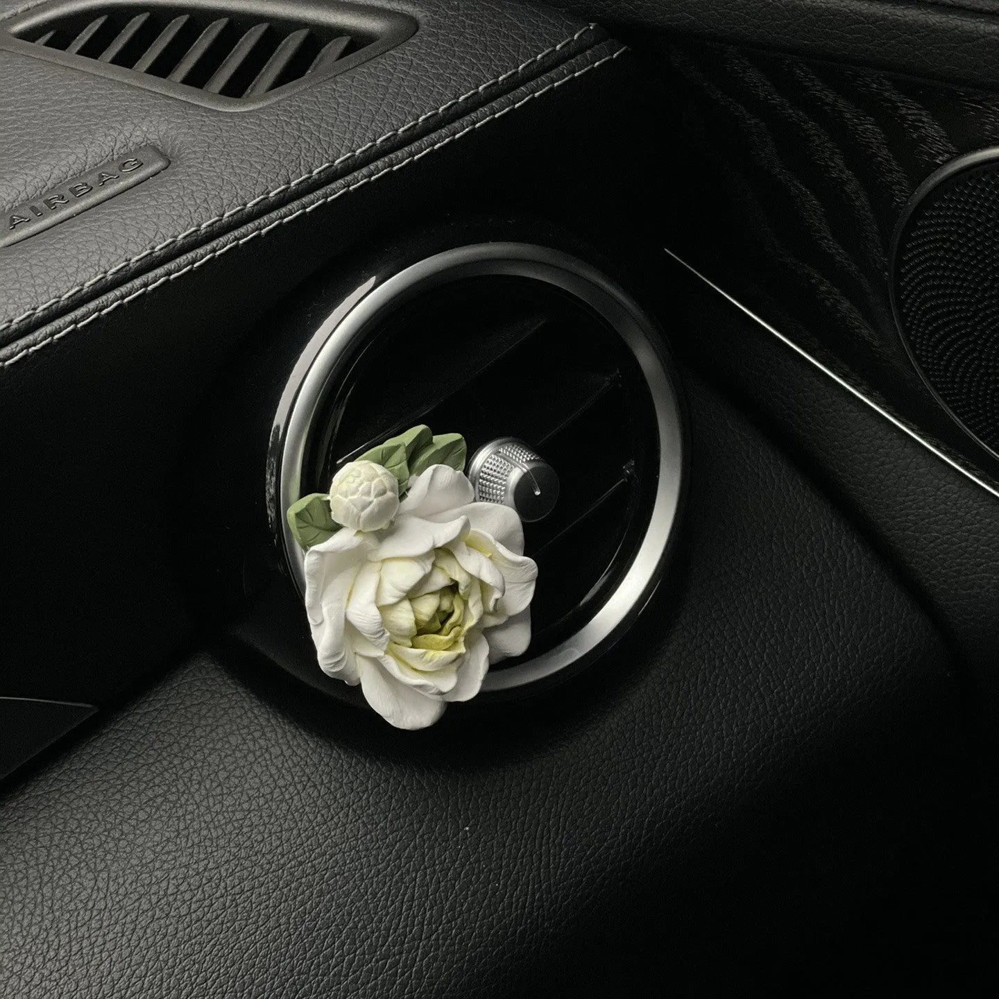 Jasmine-scented car air freshener with gypsum base clipped to vehicle vent