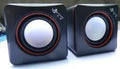 Black square USB-powered 2.0 computer speaker on desktop
