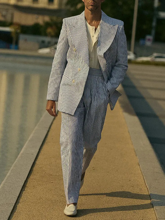 Men's blue and white striped polyester suit set with regular fit blazer and trousers on a hanger.