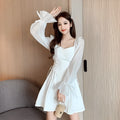 White chiffon patchwork dress on model, showing long sleeves and a long, slim-fitting skirt.