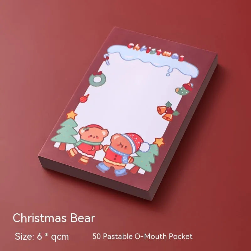 Christmas sticky notes book with cartoon designs of Santa, snowman, elf, gift, house, sled, crystal ball, and bear