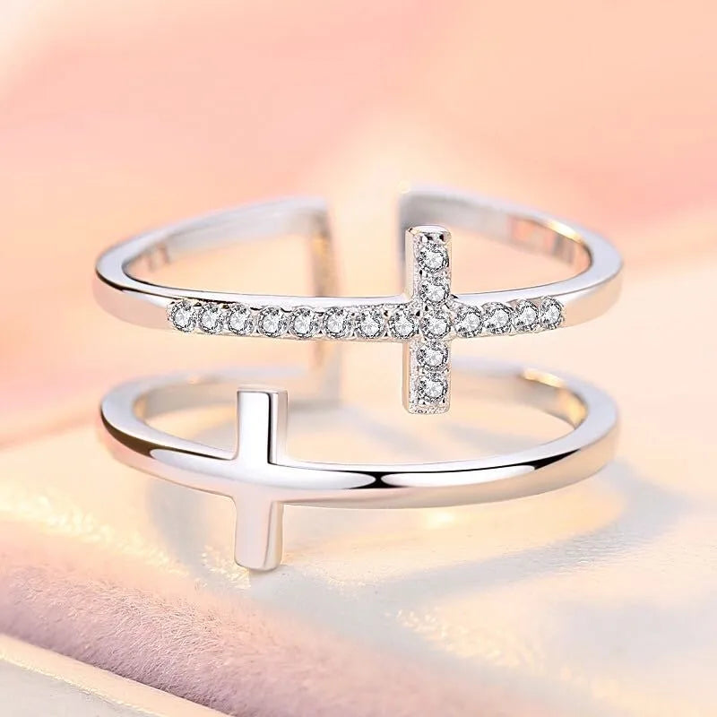 Women's double cross geometric open ring with zircon inlay on copper, showing adjustable opening.