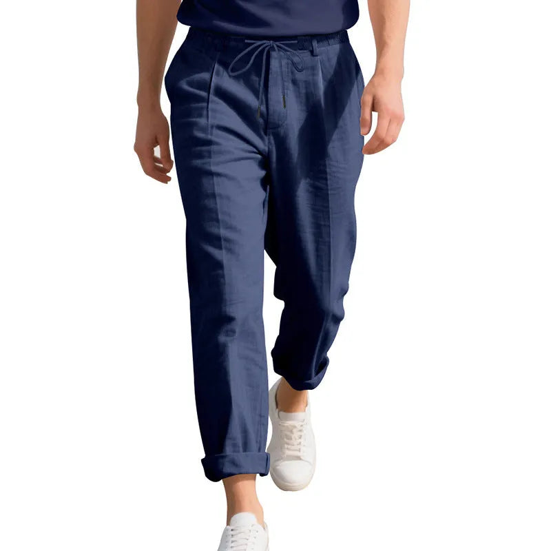 Men's loose-fit linen trousers in light khaki colour with a drawstring waistband.