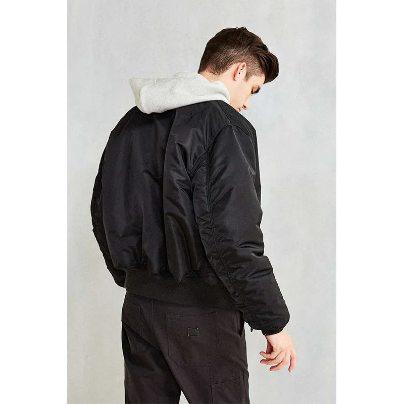 Men's army green American workwear style cotton-padded nylon jacket with a loose fit on a hanger.
