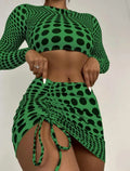 Women's green and yellow polka dot three-piece swimsuit set with top, skirt, and bra.