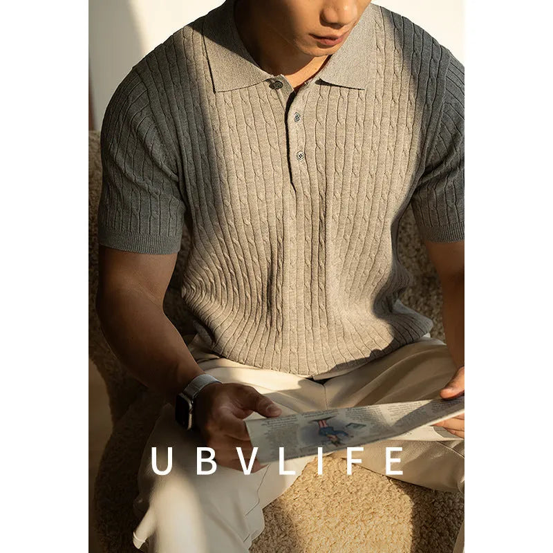 Men's khaki short sleeve business casual top on a hanger.