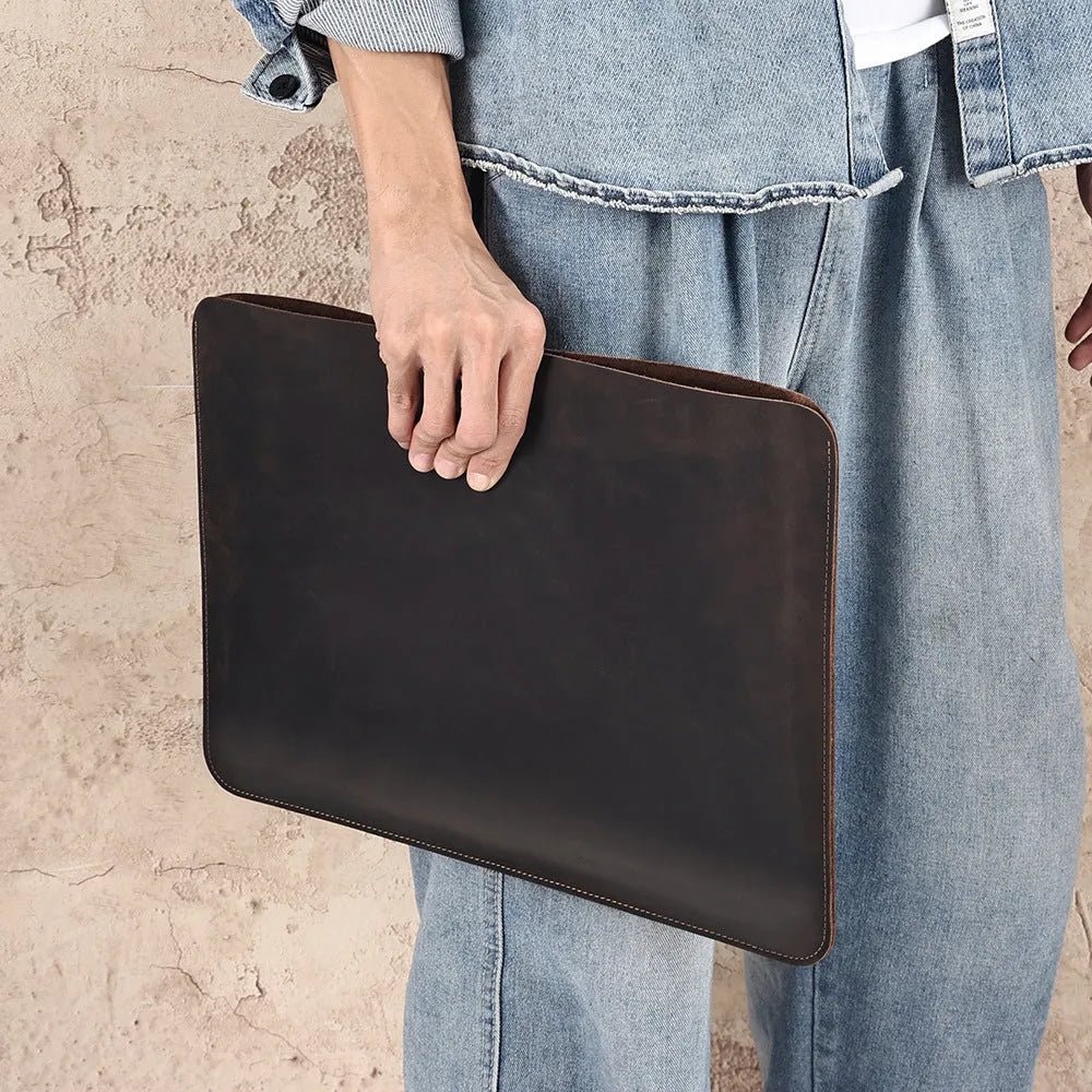 Brown genuine leather horizontal computer liner bag with cowhide lining showing interior compartments