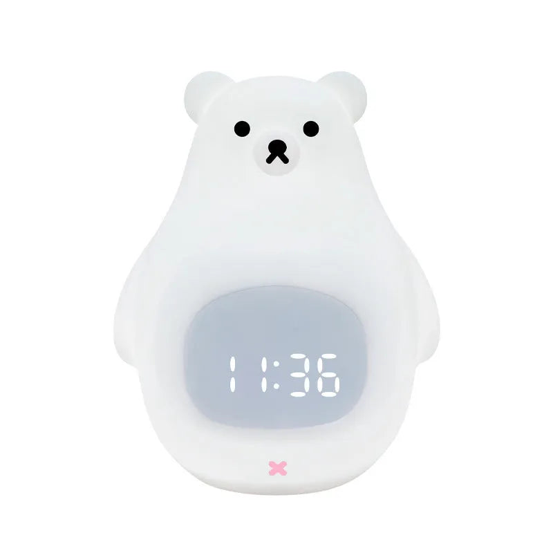 White cartoon bear silicone night light with remote control on a bedside table.