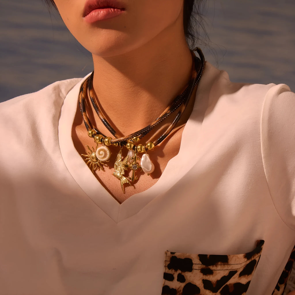 Leopard print geometric pendant on stainless steel necklace with gold-plated accents