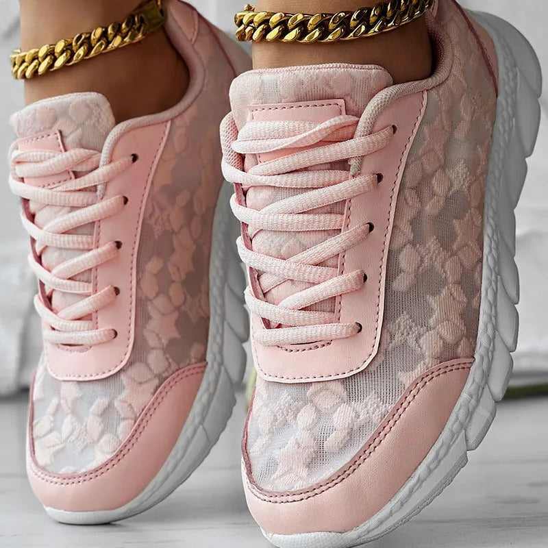 Women's white canvas casual sports shoes with soft bottom and flat heel on a light background.