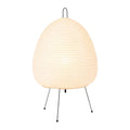 Japanese style rice paper table lamp with handmade shade and aluminium base on wooden surface