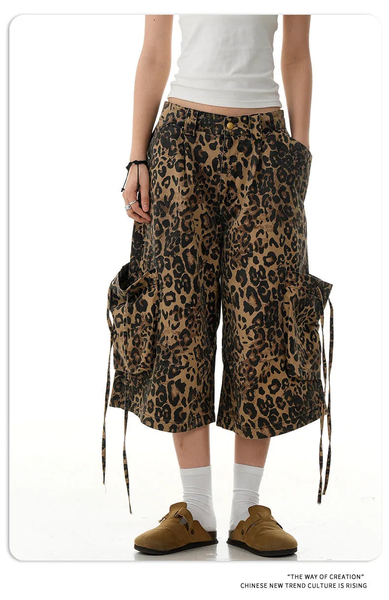 Leopard print cotton cropped trousers with a high waist and straight leg on a hanger