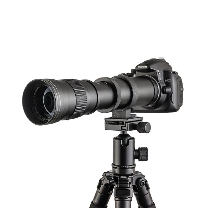 420-800mm manual telephoto zoom camera lens with T-mount adapter ring on a table