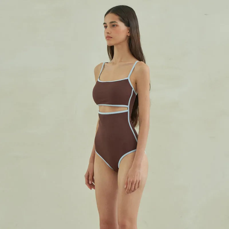 Brown women's triangle one-piece swimsuit on a hanger.