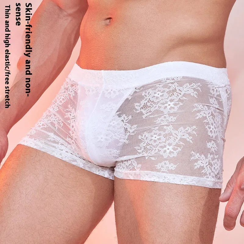 A pair of men's black lace boxer shorts made from nylon fabric.