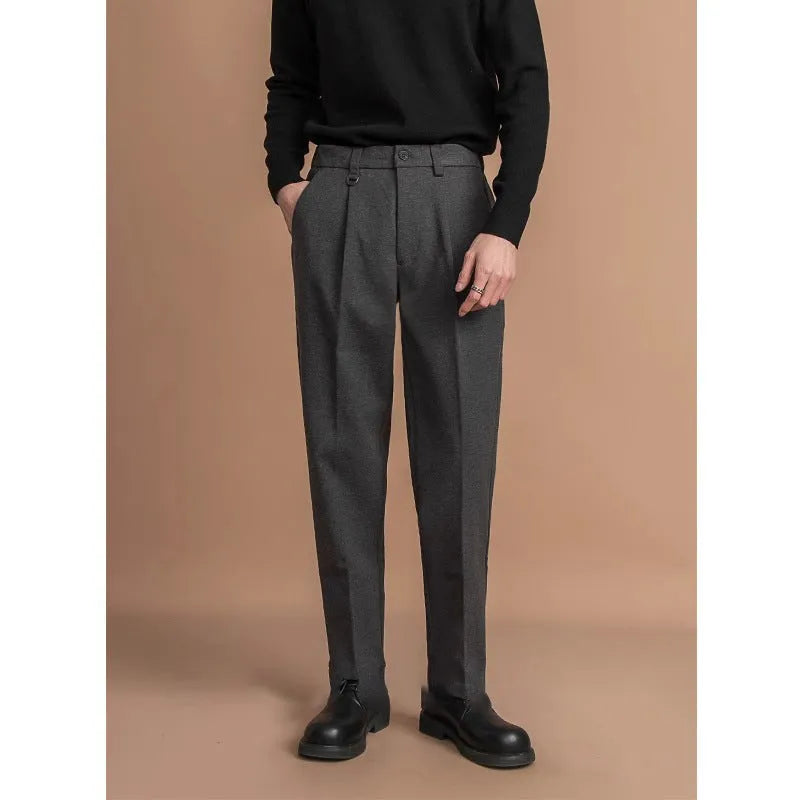 Men's straight leg casual pants in black with a draped fit, shown on a hanger.