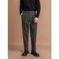 Men's straight leg casual pants in black with a draped fit, shown on a hanger.