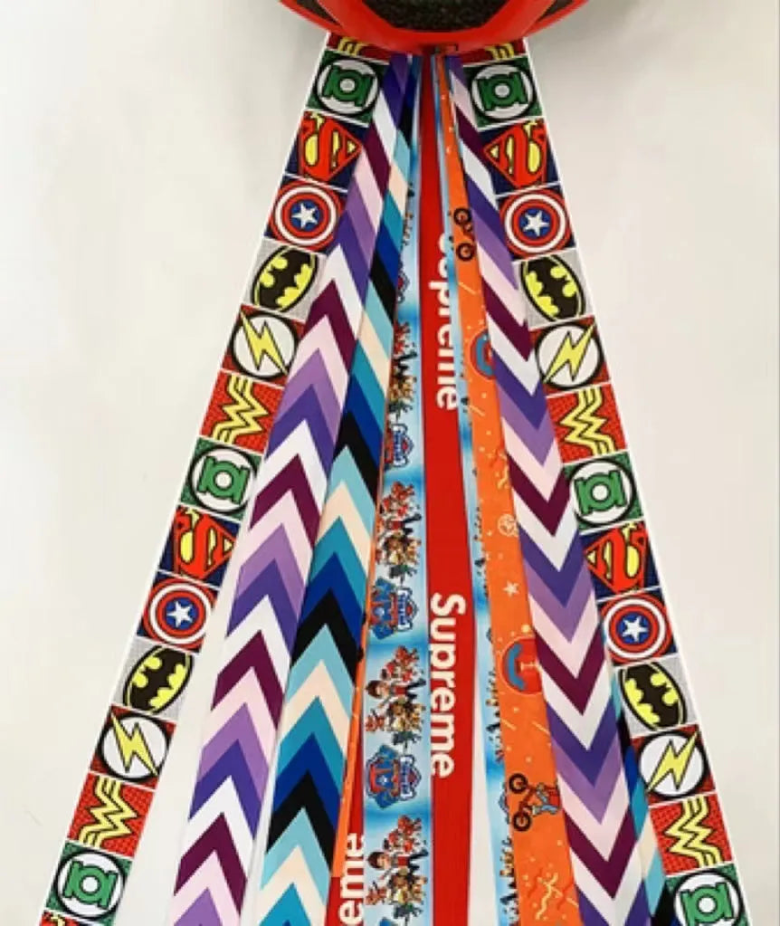Colourful decorative ribbon streamer for attaching to a child's sports helmet.