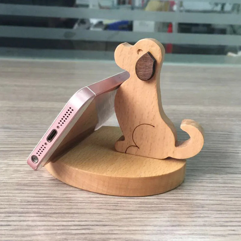 Solid beech wood mobile phone stand with a decorative resin animal ornament and a coin slot.