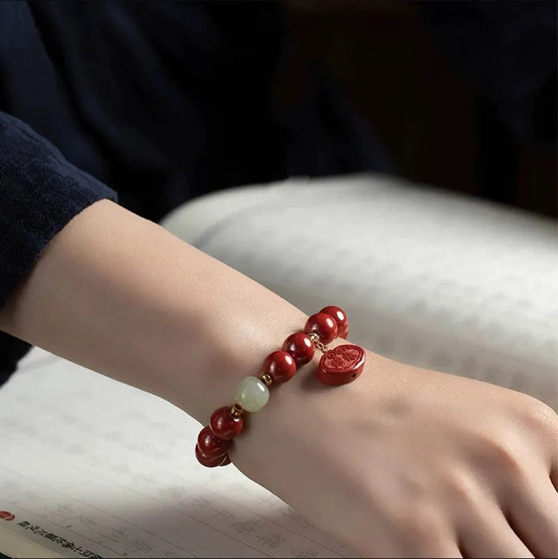 Natural cinnabar bracelet with emperor sandstone Ping An Fu Lu design, shown in 8mm and 10mm bead size options.
