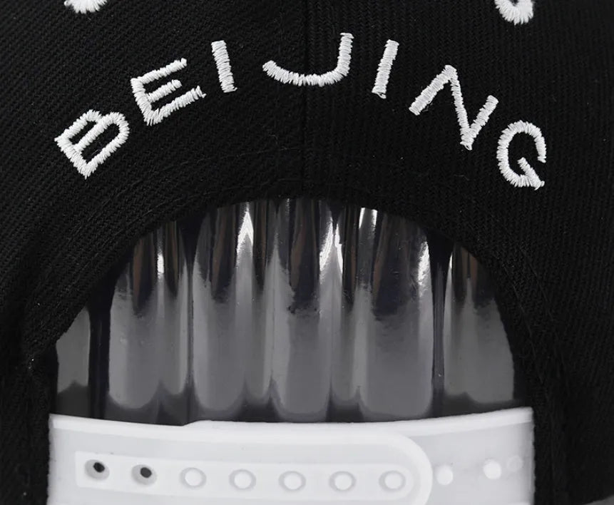 Adjustable cotton baseball cap with dome crown and letter embroidery in black or white