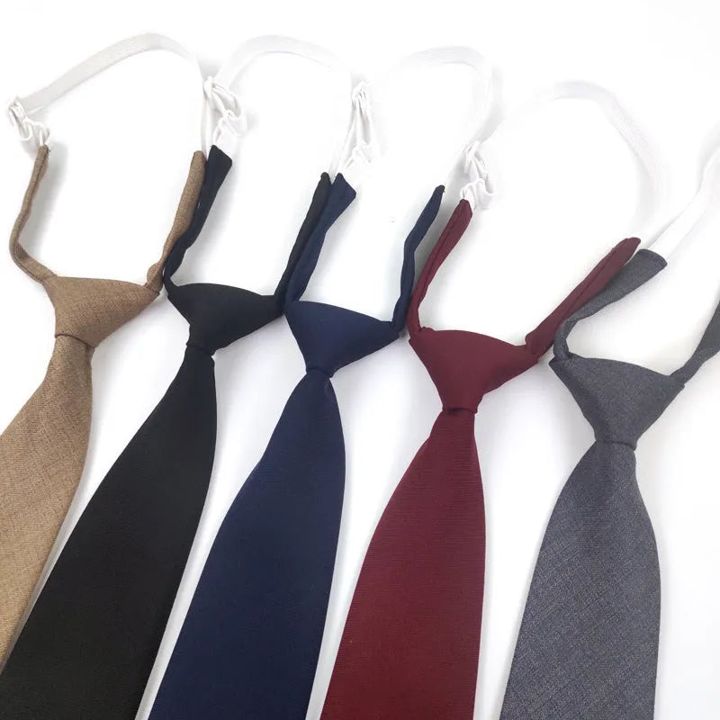 Solid colour men's cotton bow tie in arrow style laid flat, showing navy blue colour option.