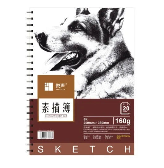 A4 sketchbook with coil binding lying flat open, showing blank heavyweight drawing paper.