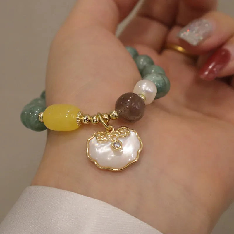Natural green jade stretch bracelet with polished beads on wrist