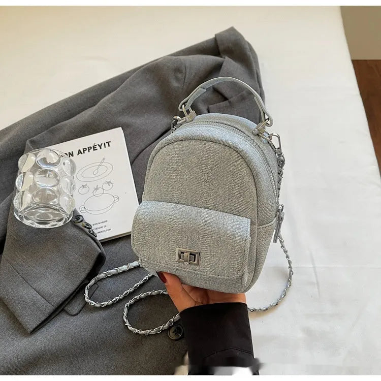 Korean style solid colour PU backpack with three-dimensional pocket, available in black, beige, blue, dark blue and khaki.