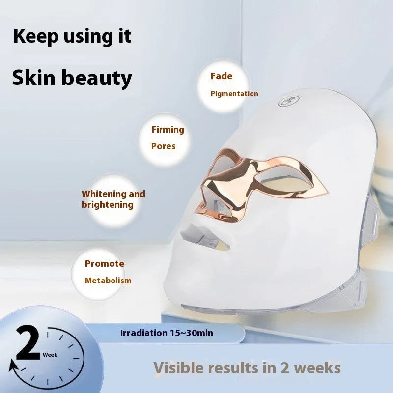 White rechargeable LED beauty mask with touch controls and adjustable head strap on a table.