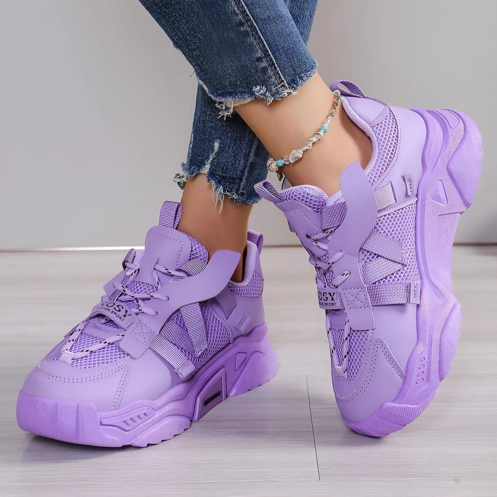 Women's purple platform mesh sports trainers with animal pattern and lace-up front on a white background.