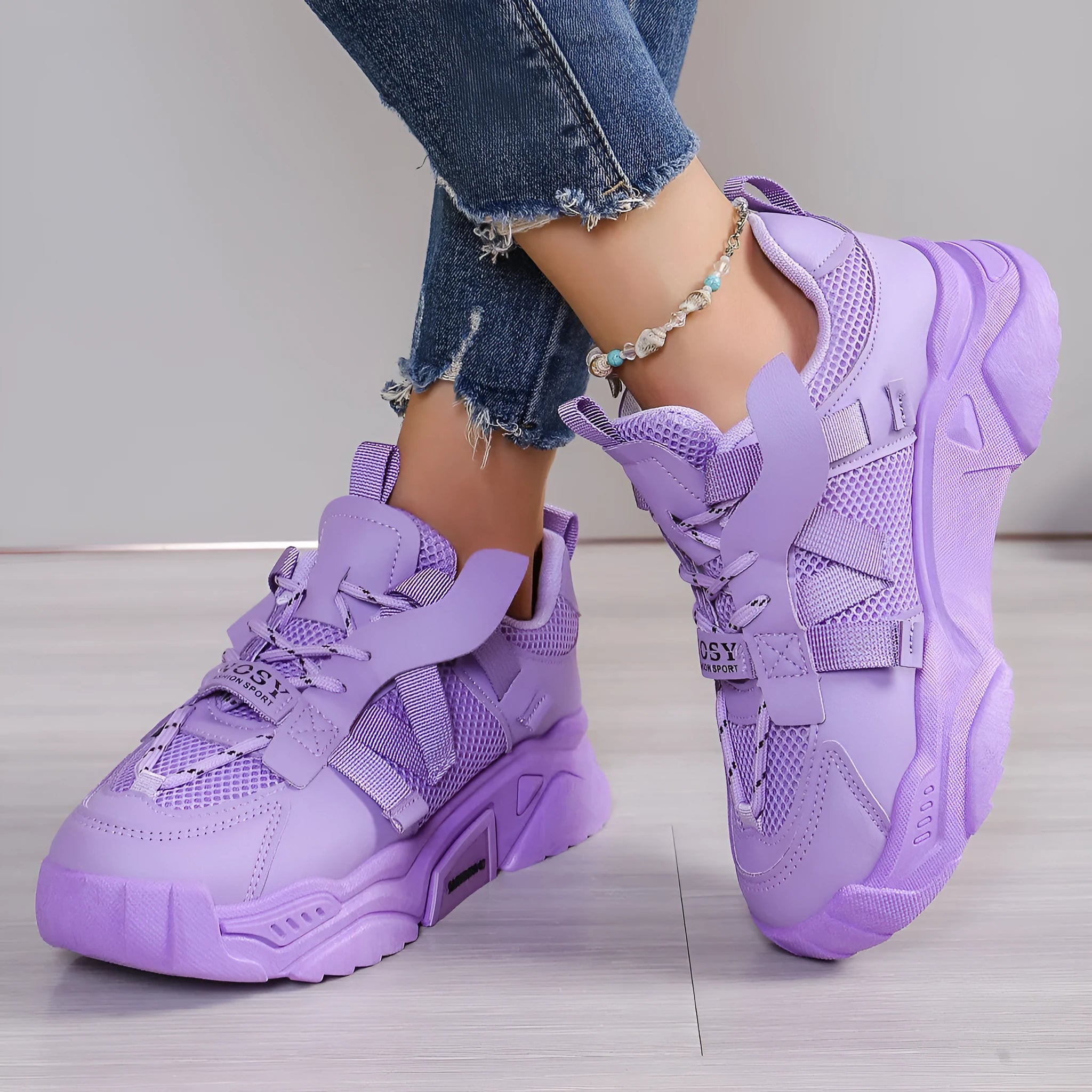 Women's purple platform mesh sports trainers with animal pattern and lace-up front on a white background.