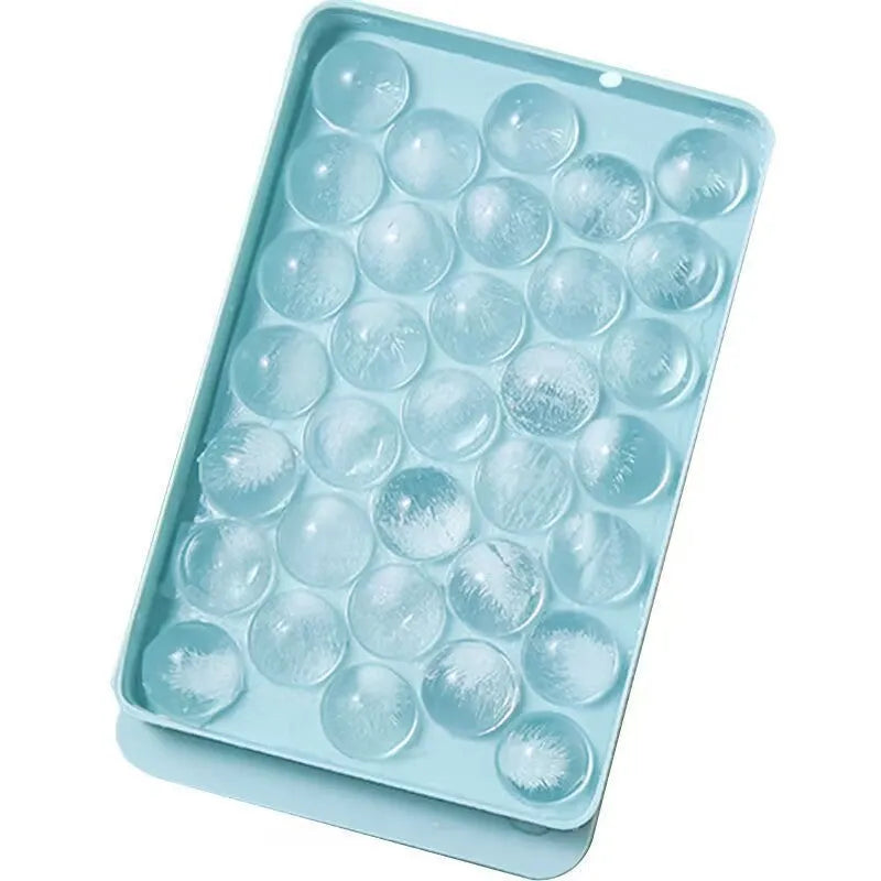 Blue round silicone ice cube tray with 33 grids and a clear lid, shown next to pink version