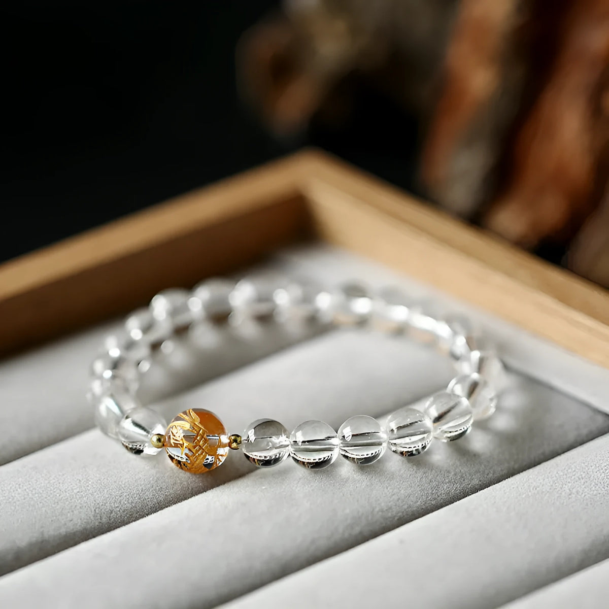 Unisex geometric bracelet with black obsidian, white crystal beads, and a golden dragon bead on a wrist.