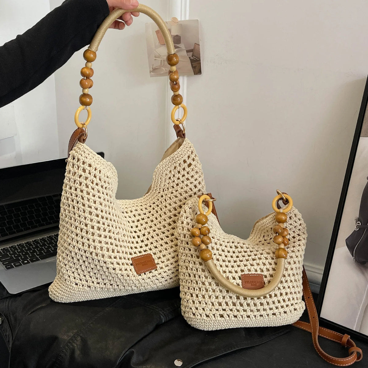Knitted beach tote bag with crossbody strap showing stitching details and bucket shape