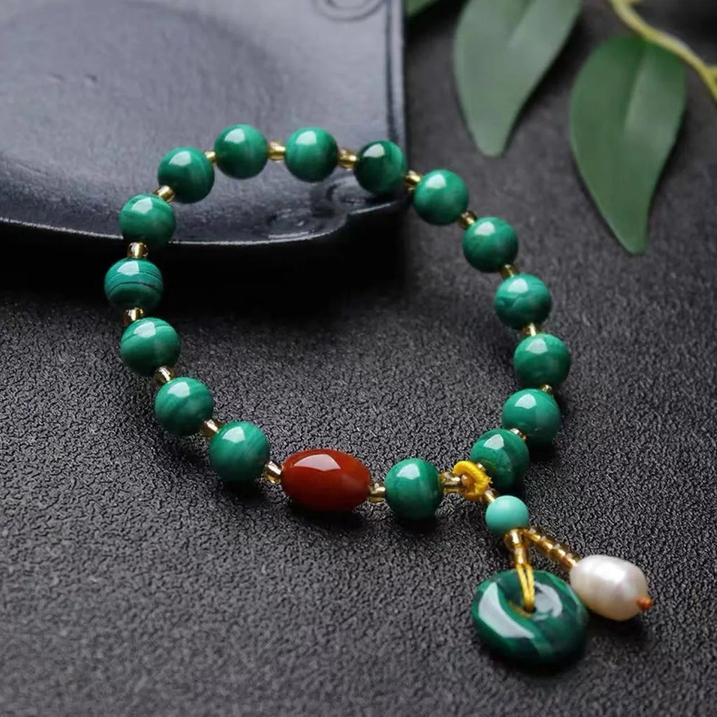 Natural malachite and southern red agate bracelet with 7-8mm round barrel beads on wrist