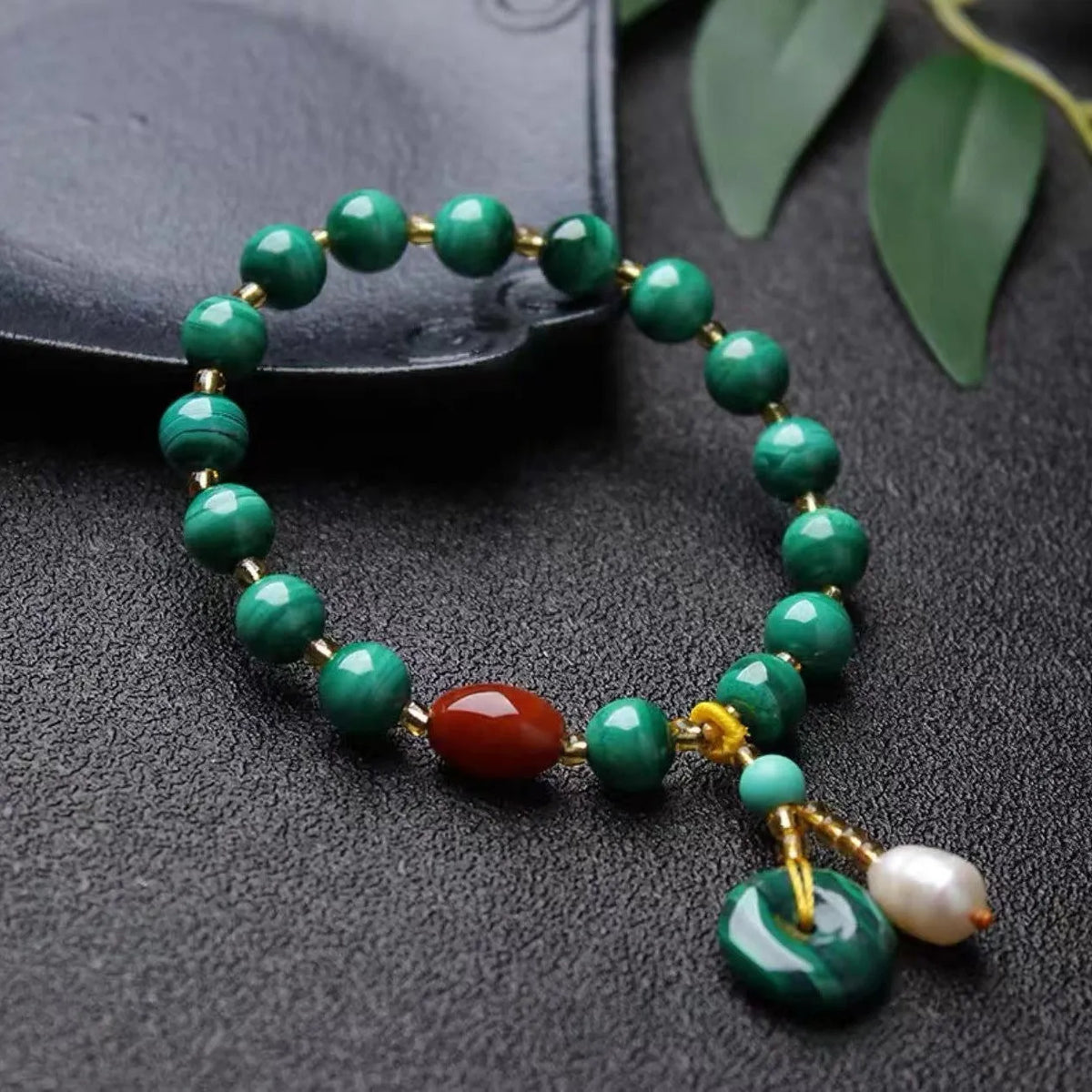 Natural malachite and southern red agate bracelet with 7-8mm round barrel beads on wrist